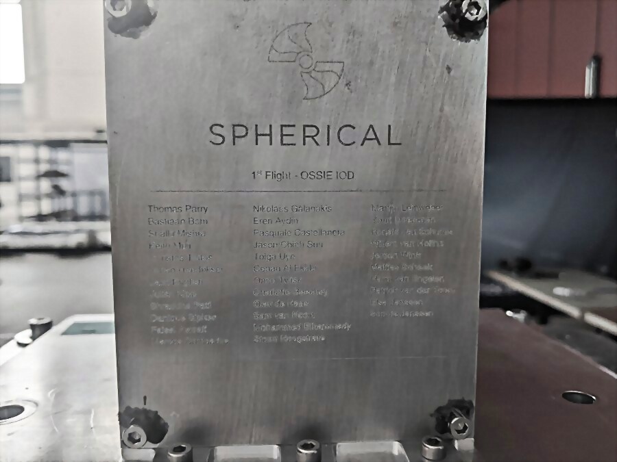 Engraved aluminium nameplate reading Spherical, 1st Flight — OSSIE IOD, listing the crew who built it.