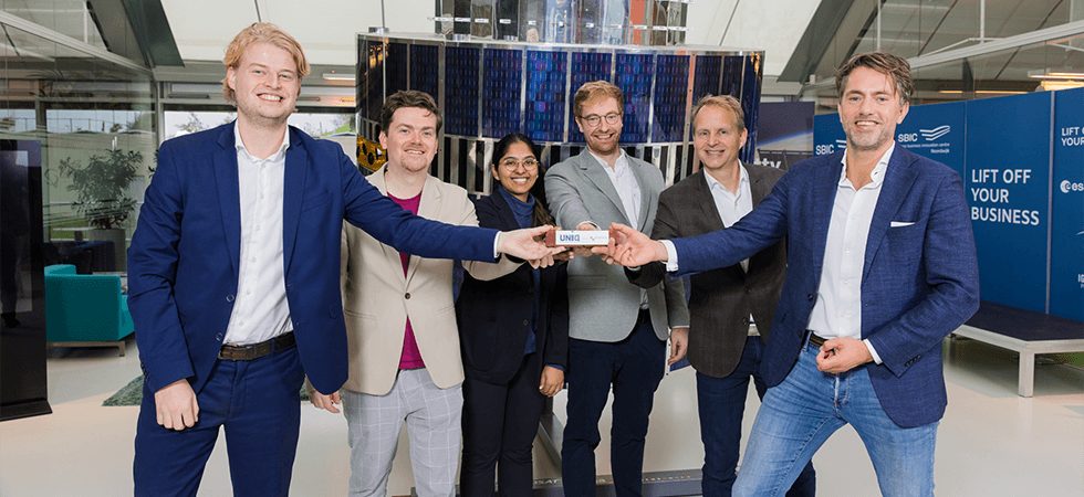 The Spherical team and investors at SBIC Noordwijk, holding a satellite model.